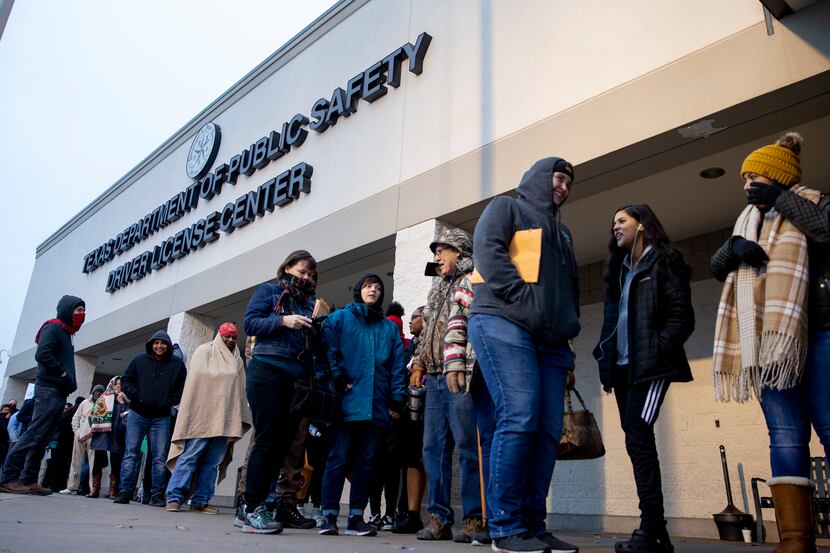 People line up outside the entrance at the Texas Department of Public Safety Driver License...