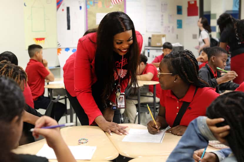 Principal Nesha Maston helps 11-year-old Alexis Grant with some work at Tasby Middle School...