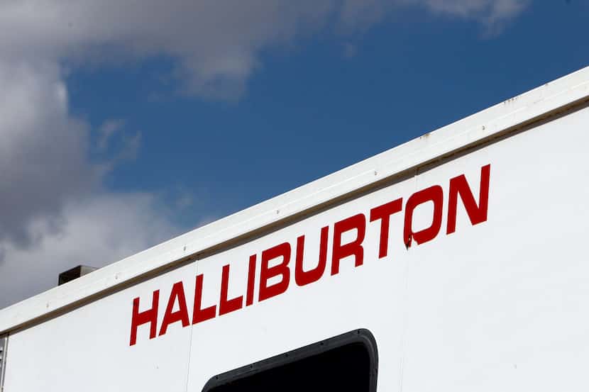 FILE - In this April 15, 2009, file photo, the Halliburton sign adorns the side of a machine...