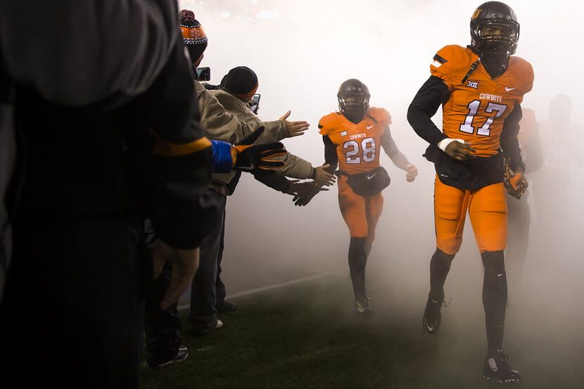 Oklahoma State wide receiver James Washington (28) and cornerback Michael Hunter (17) take...