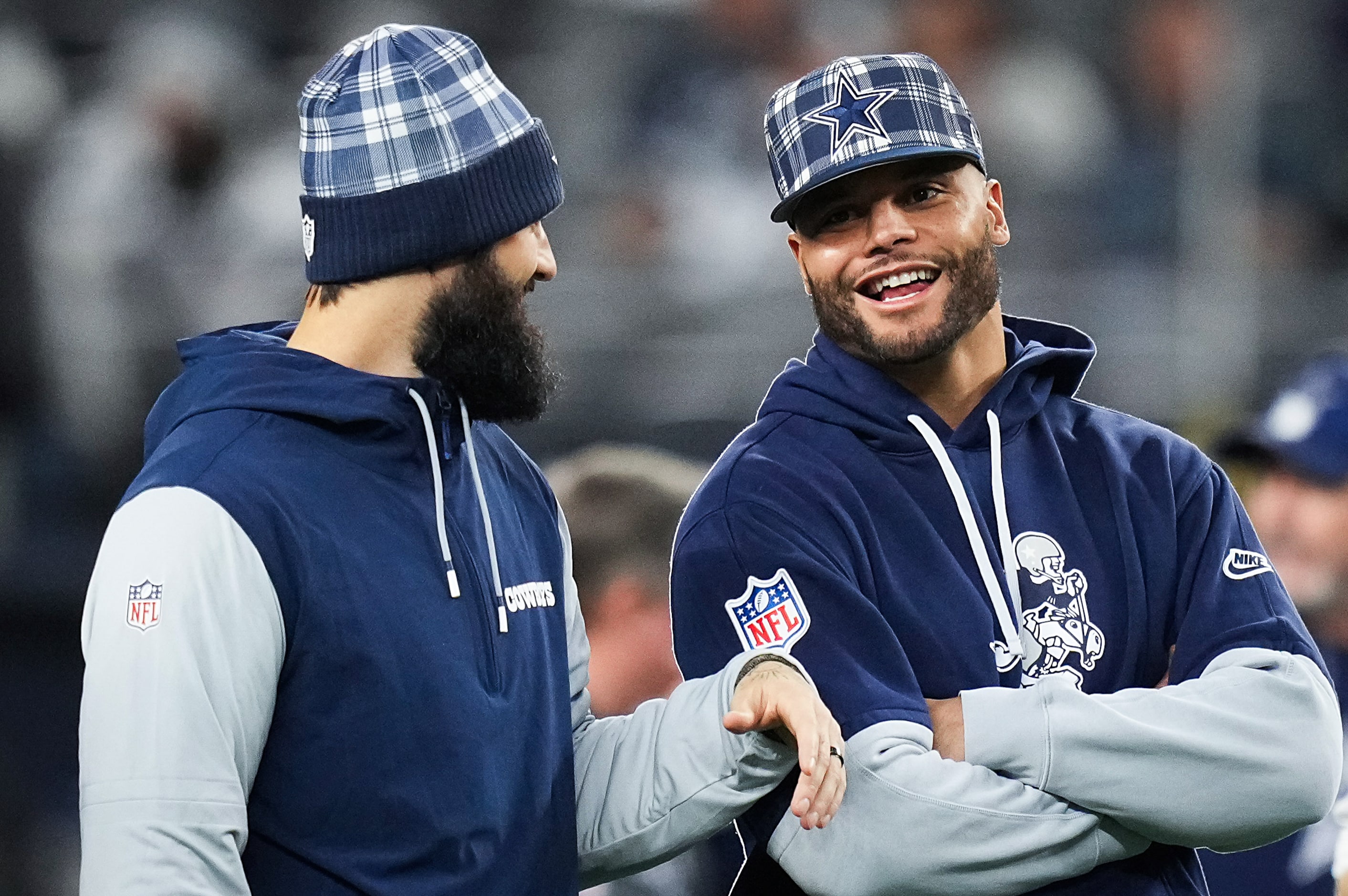 Dallas Cowboys quarterback Dak Prescott (right) talks with Will Grier as the teams warm up...