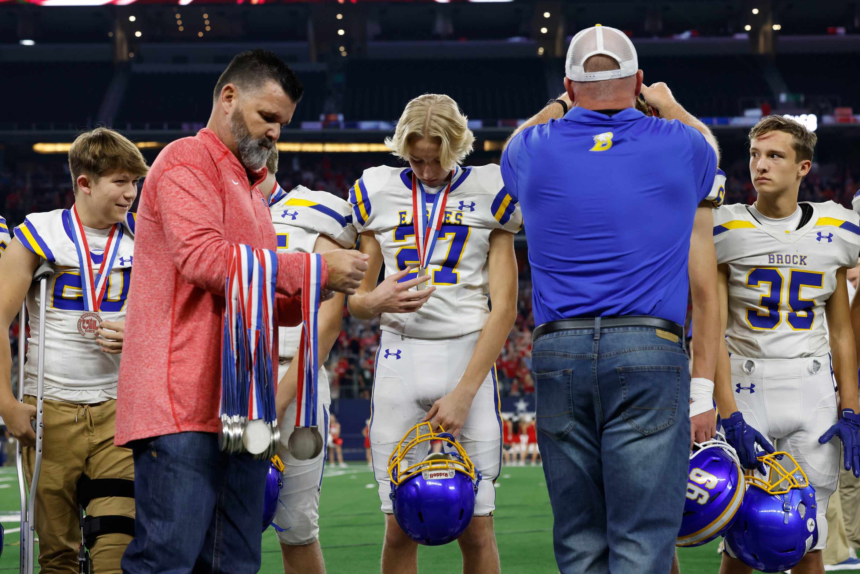 Brock wide receiver Cotton Tanner (27) admires his medal after the Class 3A Division I state...