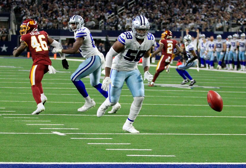 Dallas Cowboys defensive end Chauncey Golston (59) tracks a blocked punt that he will...