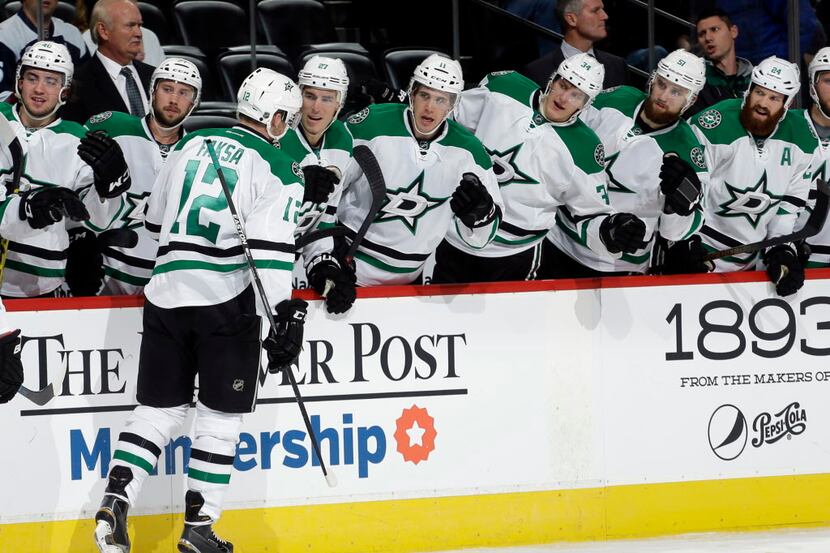 Dallas Stars center Radek Faksa is congratulated by teammates after scoring a goal against...