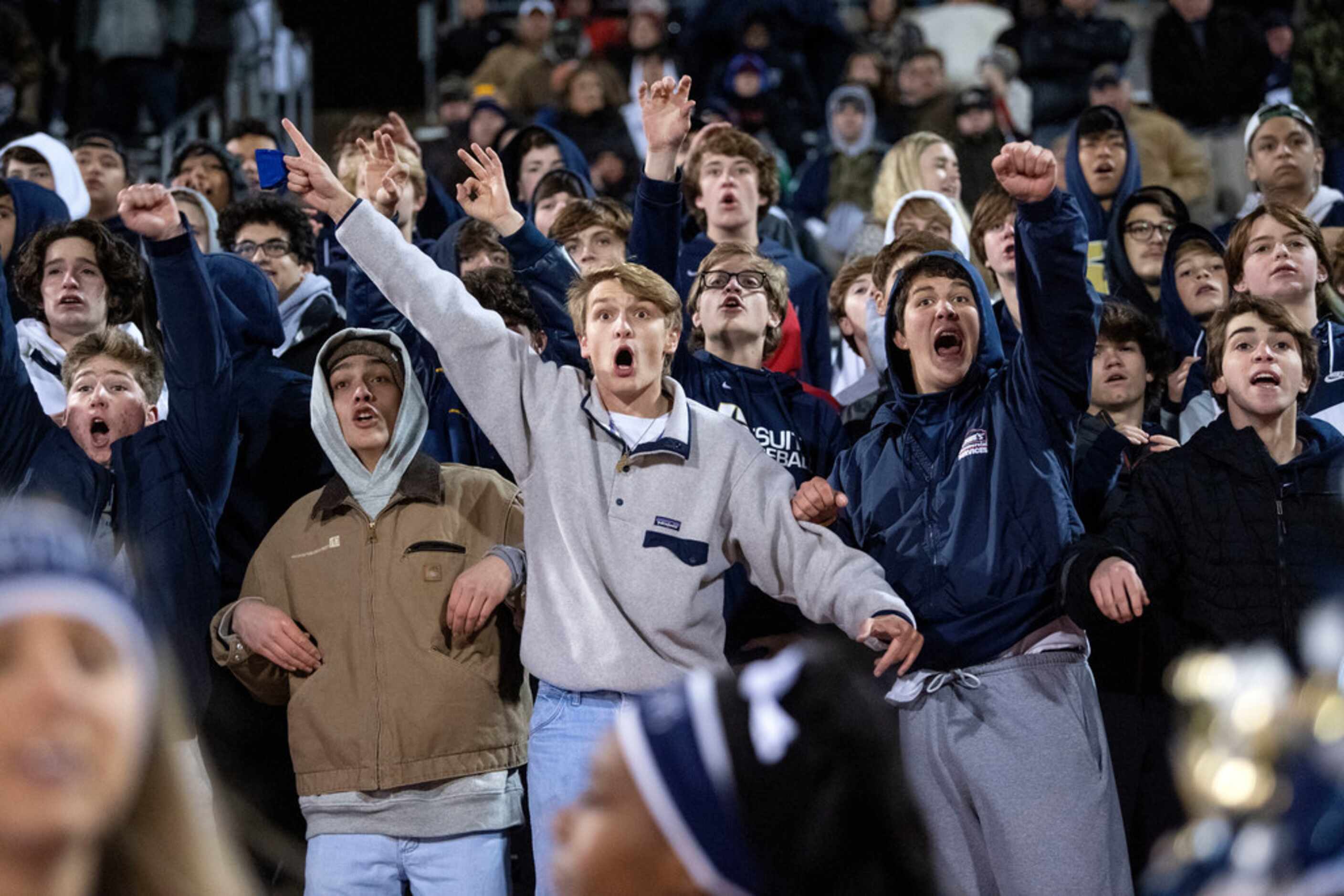 The Jesuit student section cheers on their team during an area round high school football...