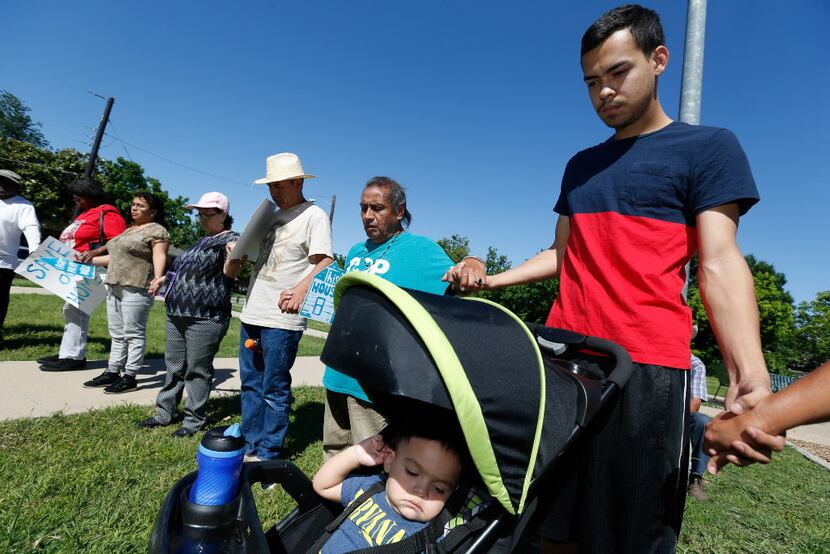 Manuel Perez, next to a stroller holding his son, 1-year-old Sebastian Liam, offered a...