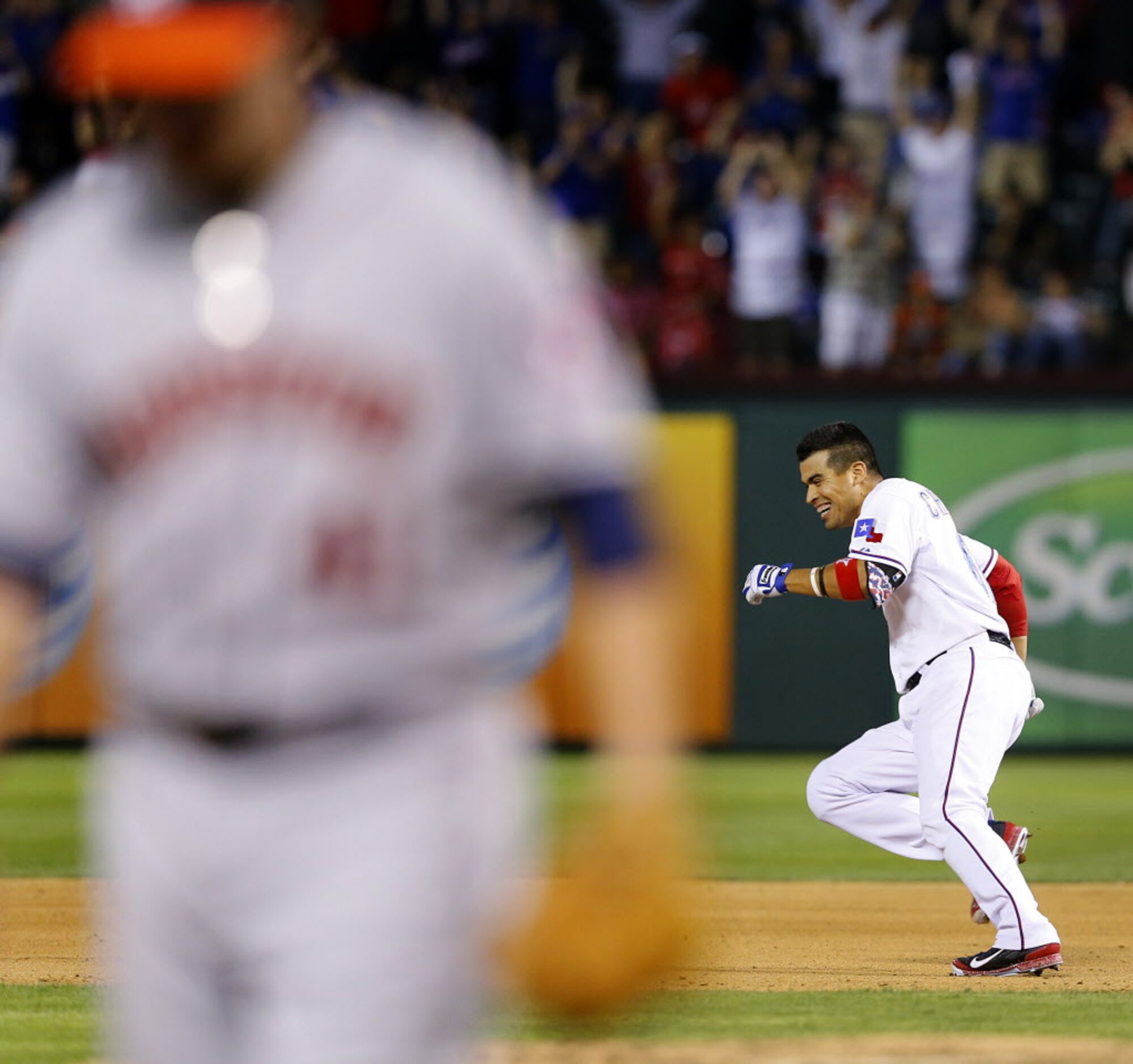 Texas Rangers Robinson Chirinos, right, runs away from teammates after hitting a single off...