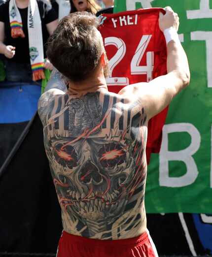 Seattle Sounders goalkeeper Stefan Frei's full-back tattoo is is view as he gives his game...