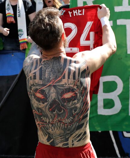 Seattle Sounders goalkeeper Stefan Frei's full-back tattoo is is view as he gives his game...