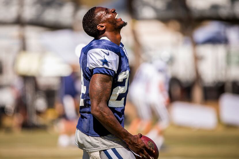 Dallas Cowboys cornerback Morris Claiborne laughs while warming up before afternoon practice...