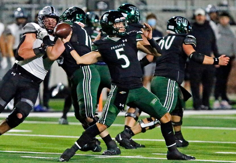 Prosper High School quarterback Jackson Berry (5) throws a pass during the first half as...