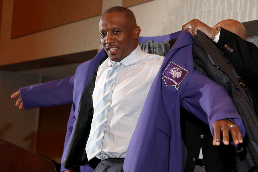 Tim Brown slips on the hall of fame jacket at the enshrinement luncheon of the Texas Black...