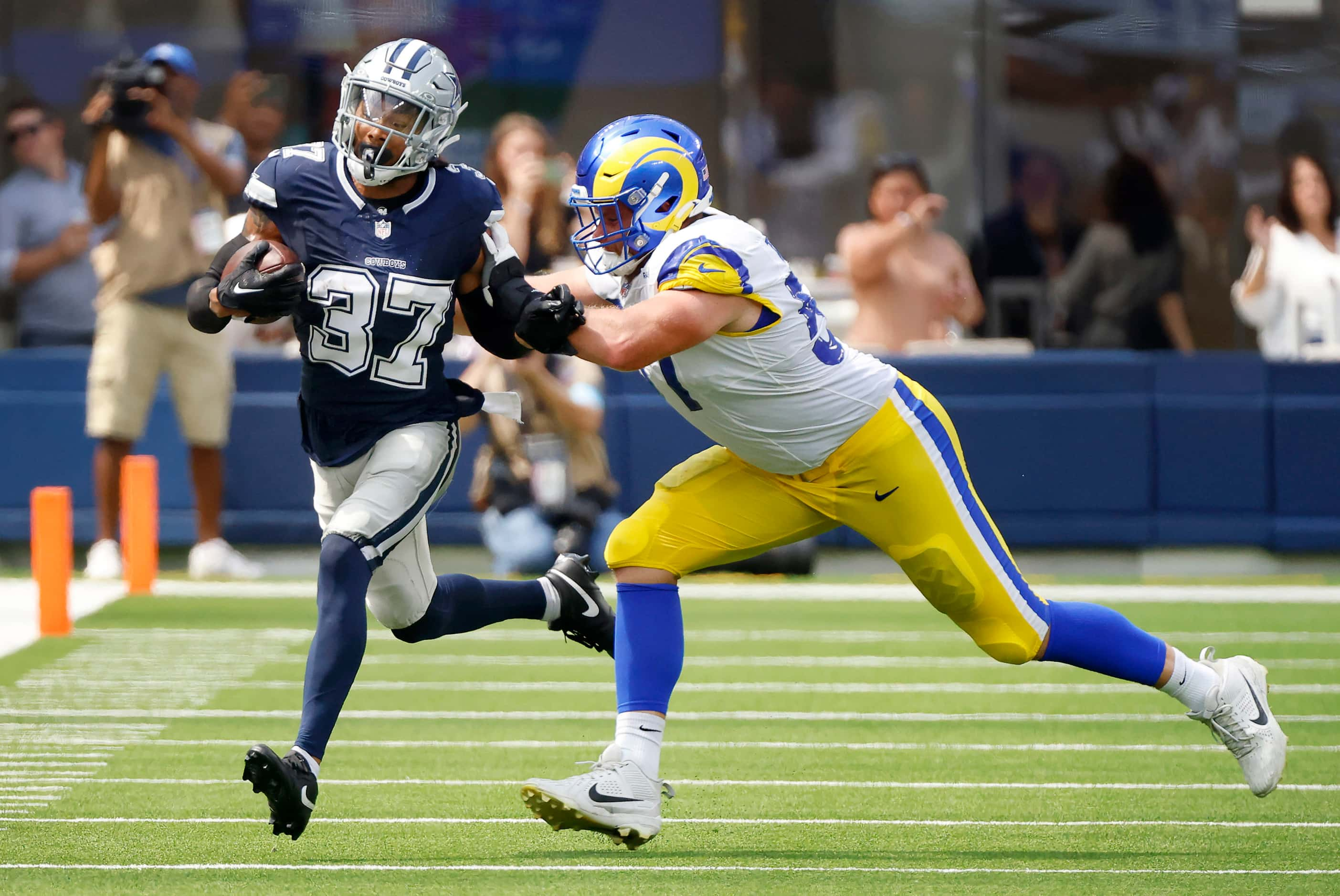 Dallas Cowboys cornerback Eric Scott Jr. (37) returns an interception by Los Angeles Rams...