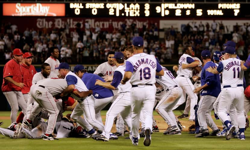 Members of the Los Angeles Angels and the Texas Rangers clash in a brawl on the field after...