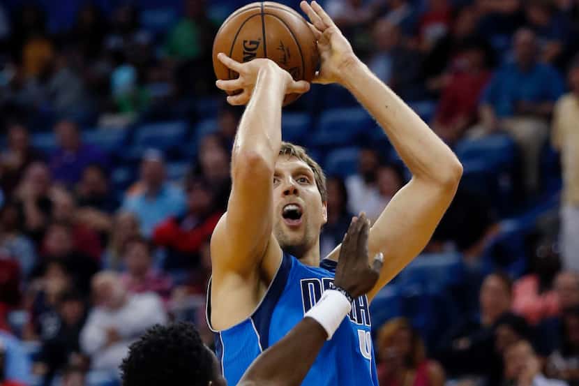 Mavericks forward Dirk Nowitzki (41) shoots over New Orleans Pelicans guard Jrue Holiday in...