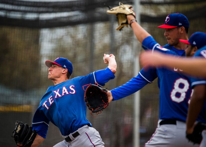 FILE - Brett Martin, left, pitches in the bullpen during a spring training workout at the...