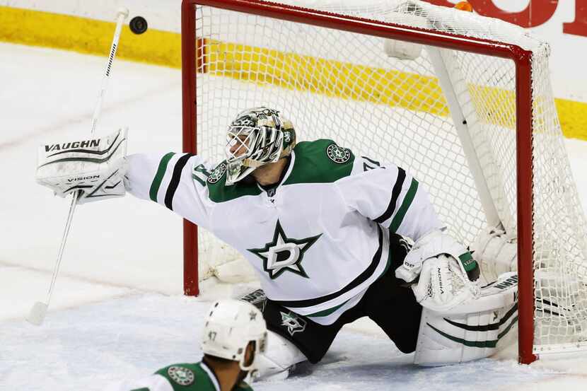 Dallas Stars goalie Antti Niemi of Finland deflects a shot during the first period of Game 4...