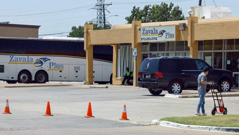 A Zavala Plus employee unloaded cones as a bus prepared for departure July 13, 2023, in...