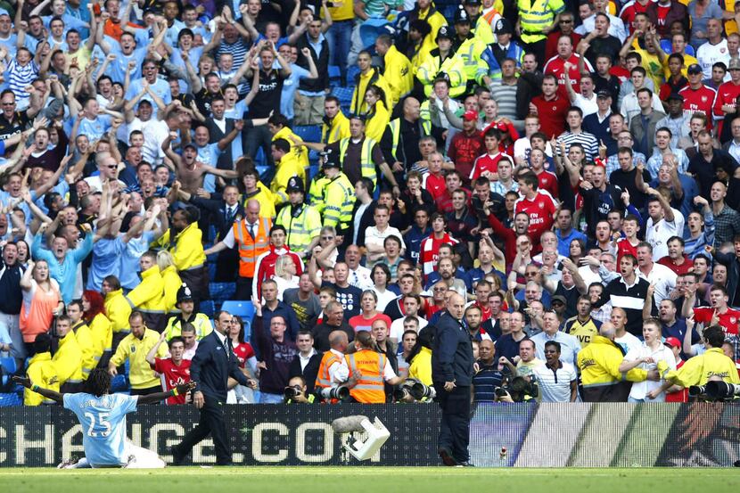 Emmanuel Adebayor celebrates in front of the Arsenal supporters after scoring for Manchester...