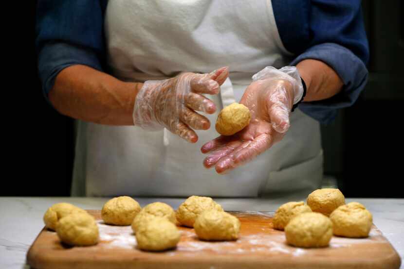 Dotty Griffith rolls dough for tortillas 