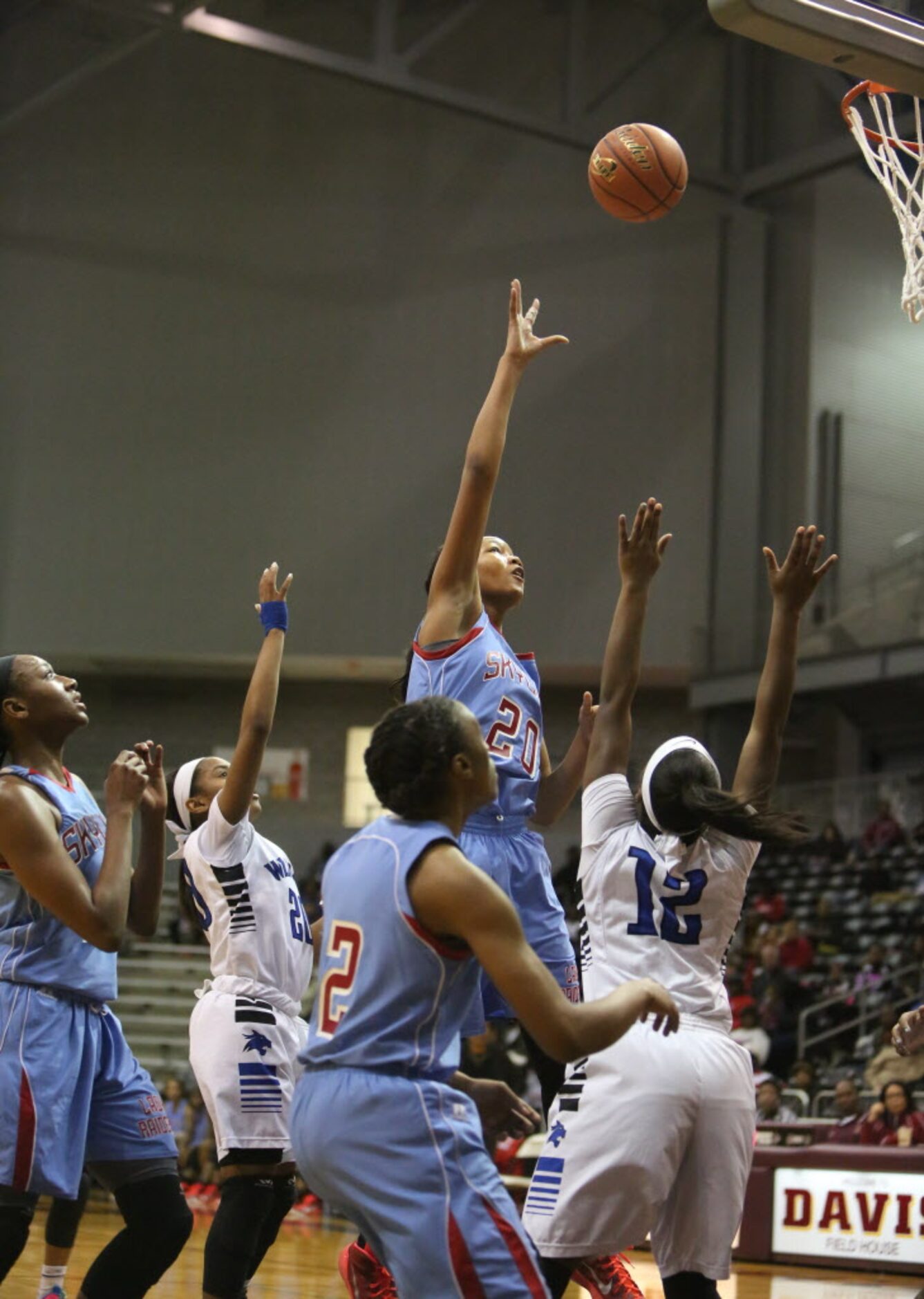 Skyline forward Dai'Ja Thomas shoots a hook shot over Dekaney's Kene Hamilton (12) during...