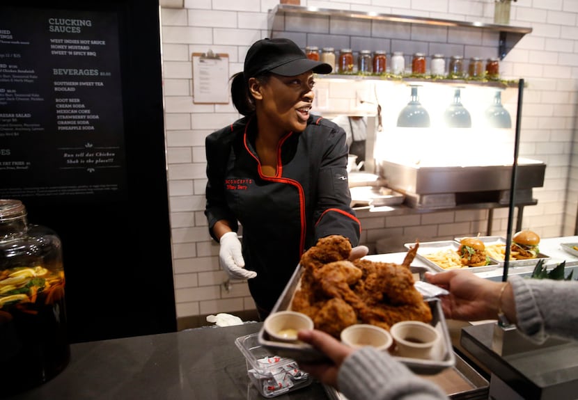 Chef Tiffany Derry serves up an order of duck-fat fried chicken wings at Roots Chicken Shak.