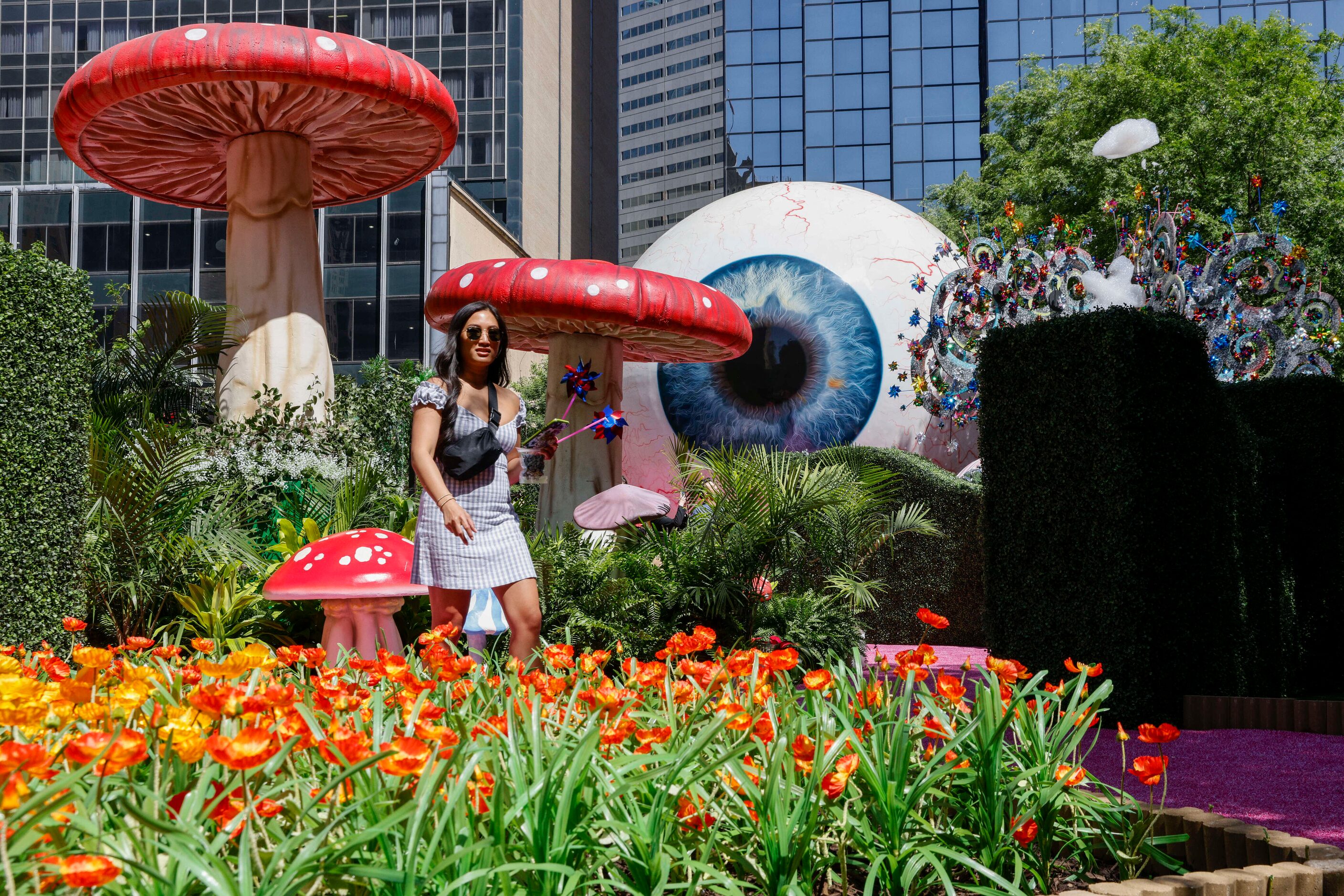 Tiffany Noel of Ohio walks past giant mushrooms at the Eyeboretum on Friday.