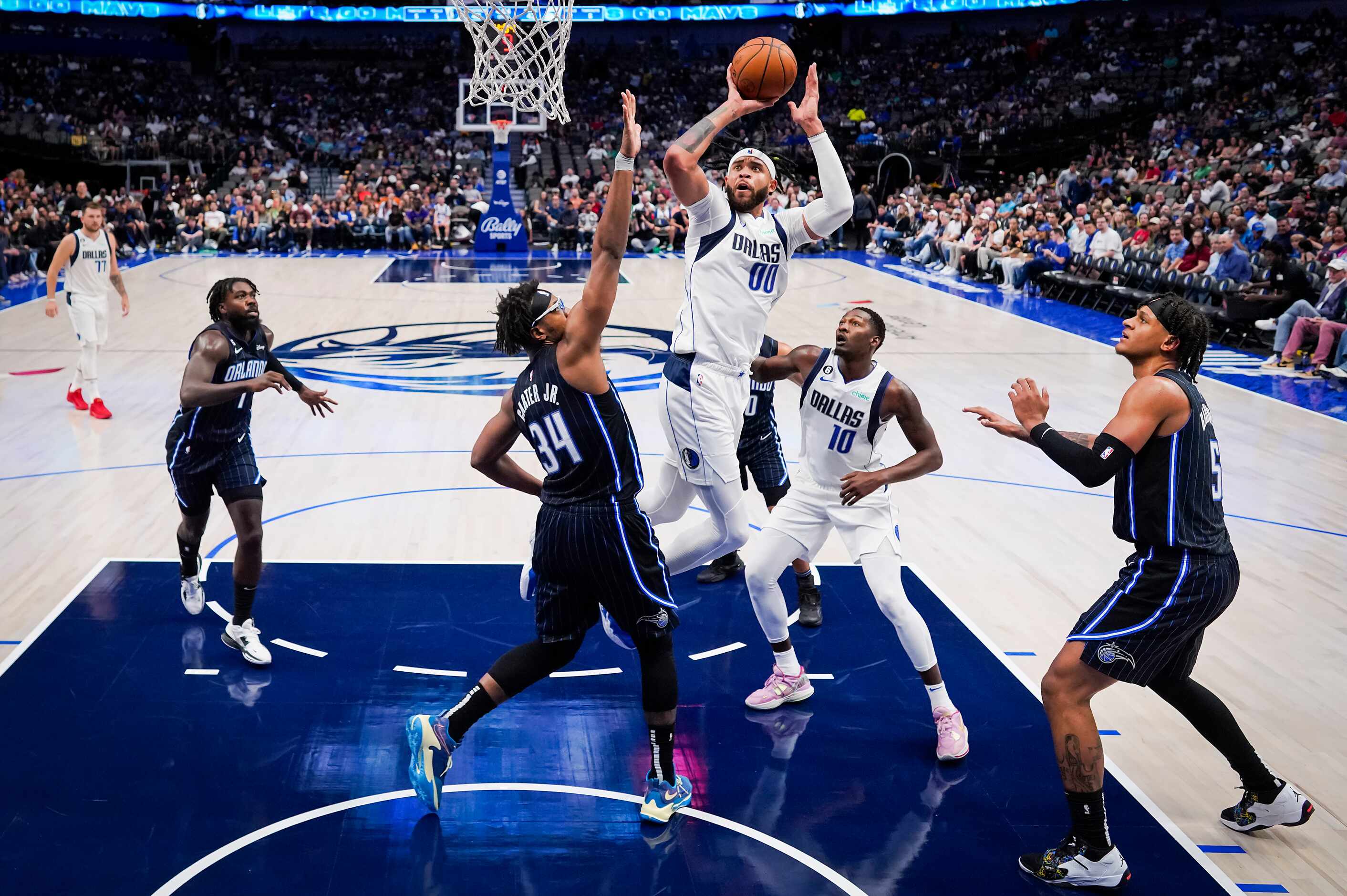 Dallas Mavericks center JaVale McGee (00) shoots over Orlando Magic center Wendell Carter...