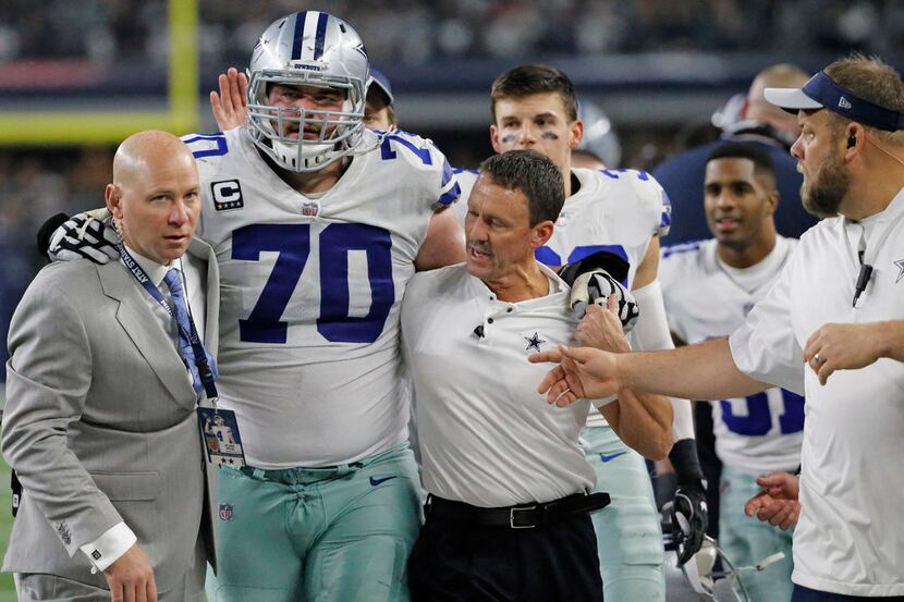 Dallas Cowboys offensive guard Zack Martin (70) is helped off the field after being injured ...