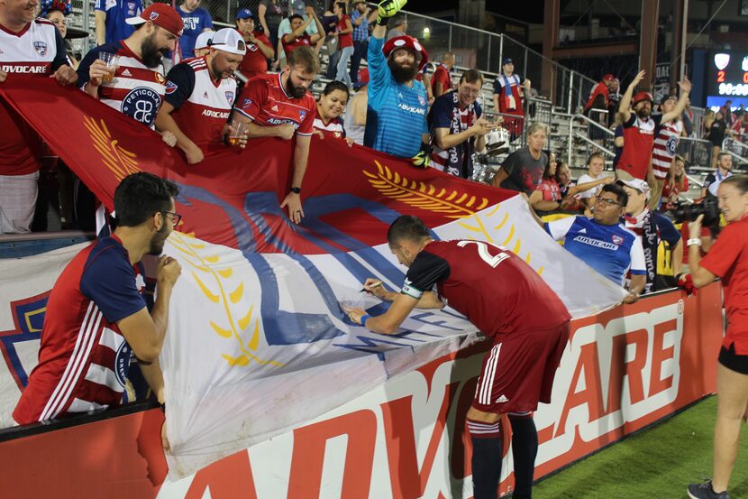 Saturday, August 18 2018 (Frisco, TX): FC Dallas captain Matt Hedges signs a banner created...