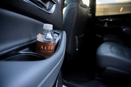 An Alto branded water bottle photographed as the car is parked curbside at Dallas Love Field...