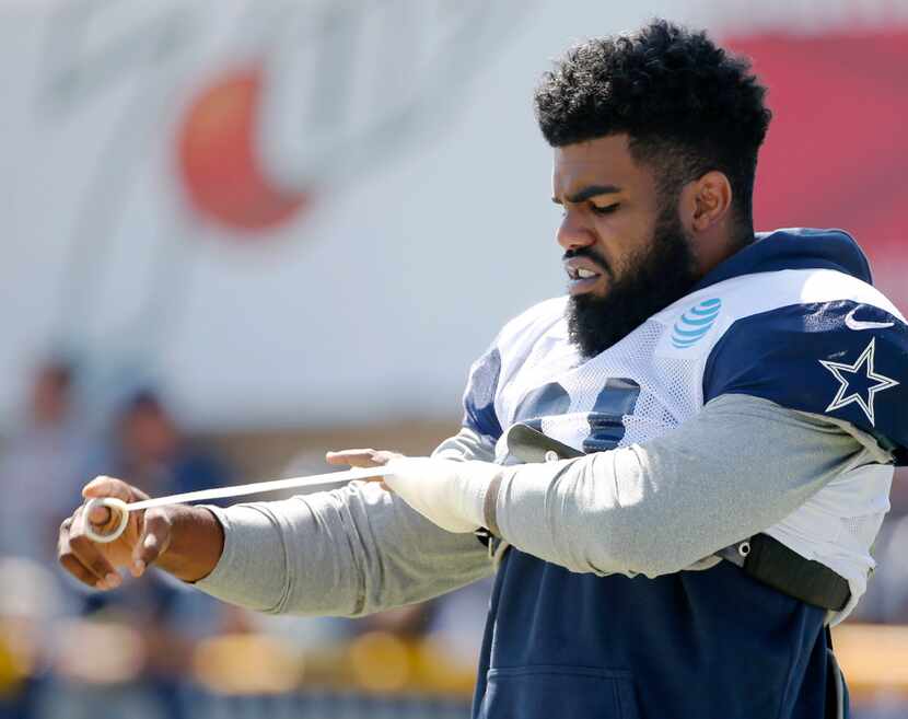 Dallas Cowboys running back Ezekiel Elliott wraps his hand before the start of practice at...