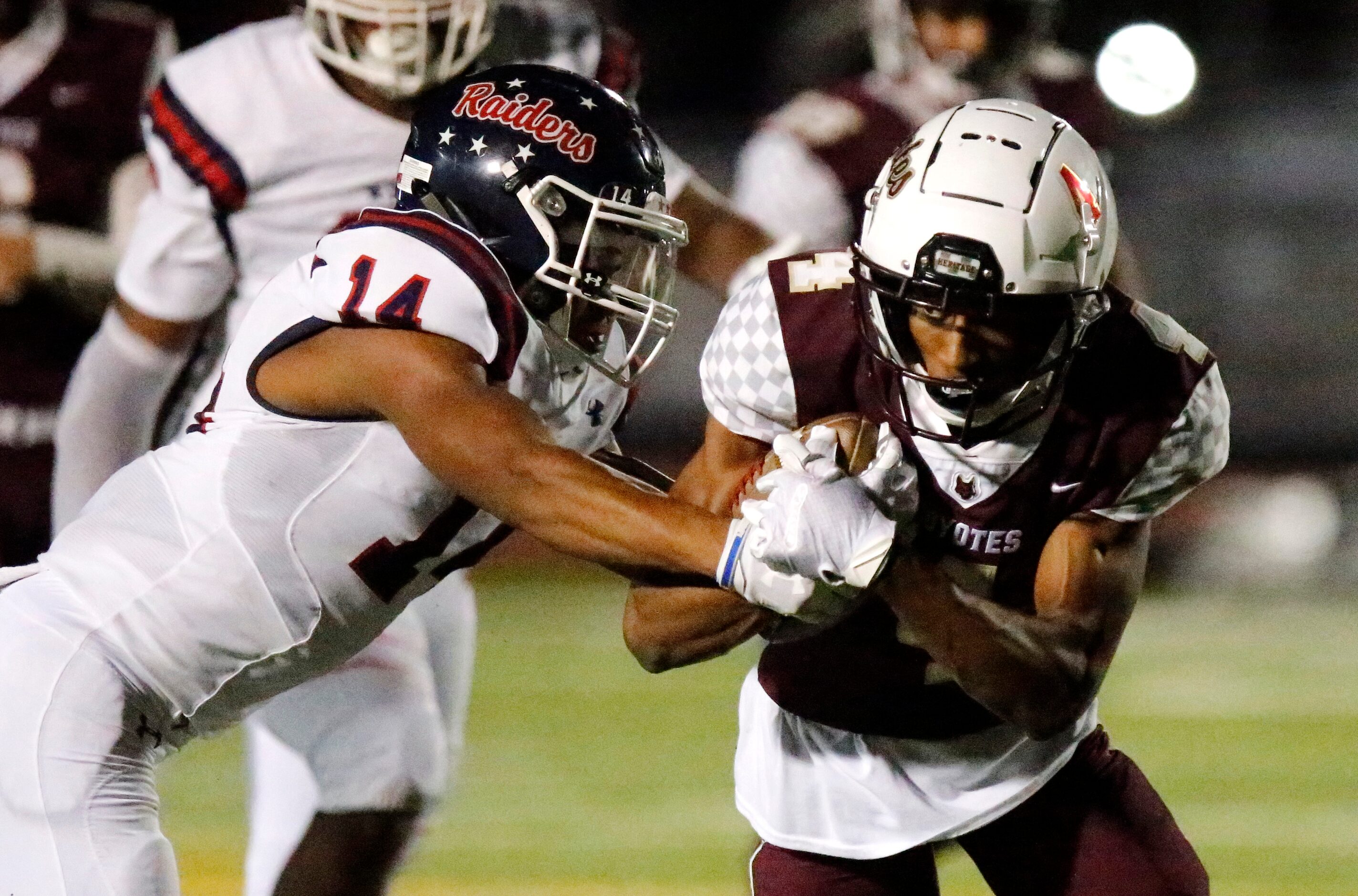 Frisco Heritage High School wide receiver Carsten Brewer (4) protects the ball as Denton...