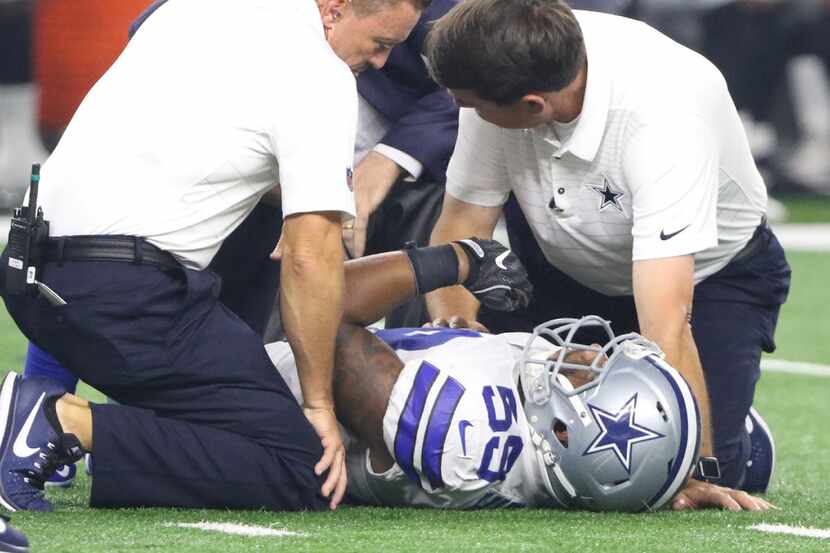 Dallas Cowboys Anthony Hitchens (59) is helped on the field after getting hurt during the...