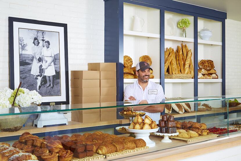 Baker Clint Cooper stands behind the counter at Boulangerie by Village Baking Co., which is...