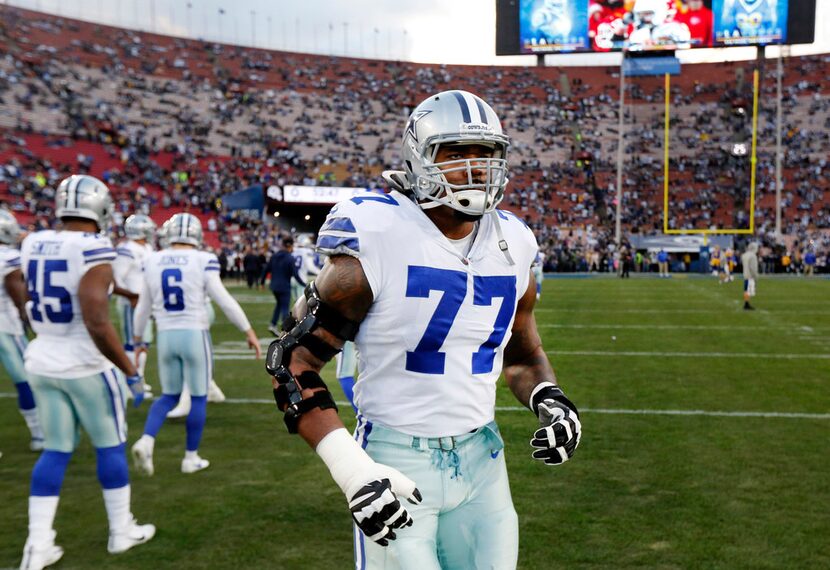 Dallas Cowboys offensive tackle Tyron Smith (77) jogs out for warmups before their NFC...