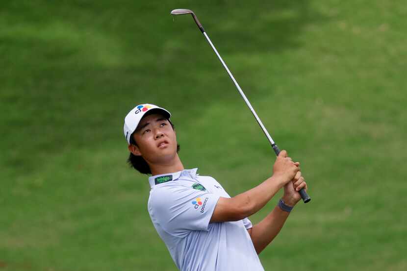 Kris Kim watches his chip shot onto the 18th green during the final round of The CJ Cup...