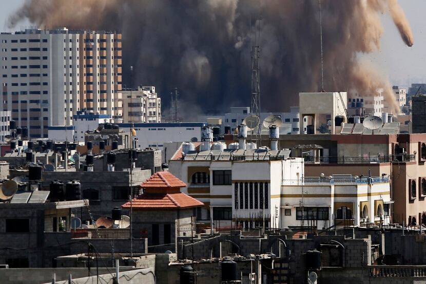 Smoke, dust and debris rise over Gaza City after an Israeli strike Friday.