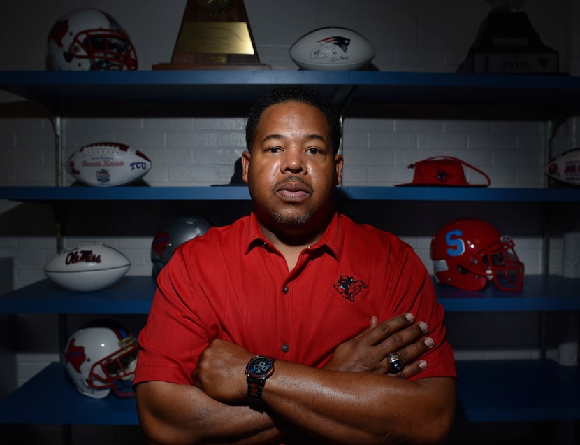 Skyline head football coach Herman Johnson in his office with a collection of football...