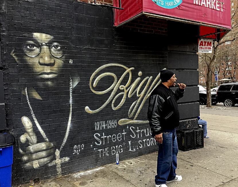 Grandmaster Caz pauses in front of a mural during the tour to reminisce about some fallen...