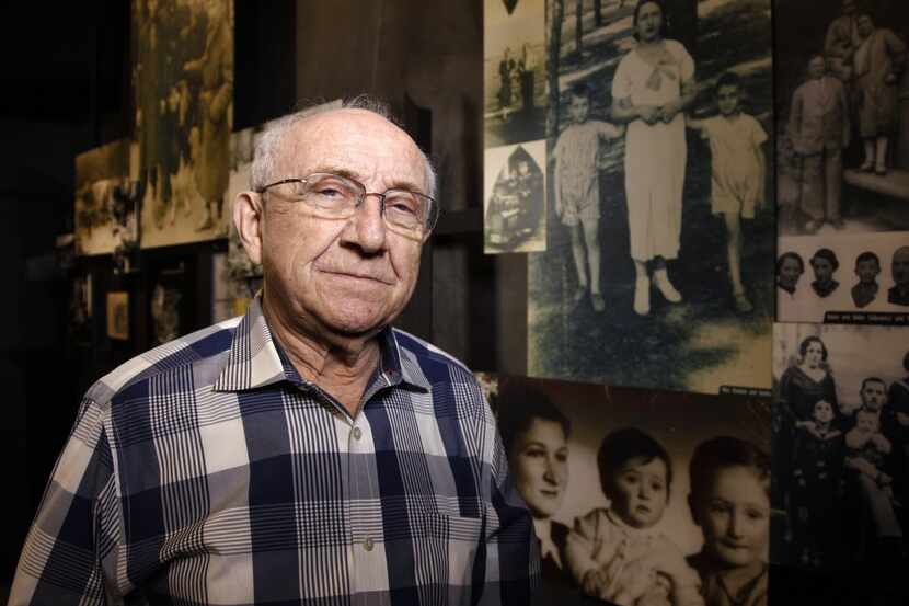 Max Glauben, 86, stands in front of some of the photographs taken of him and his mother and...