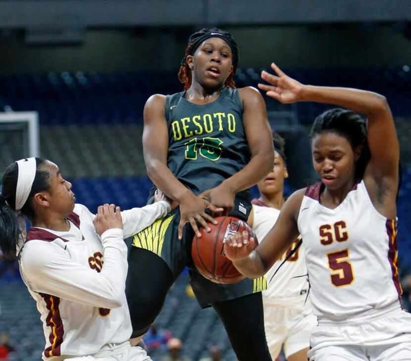 Desoto's Michayla Gatewood tries to drive between Humble's Adaora Nwokeji,L,and Humble's...