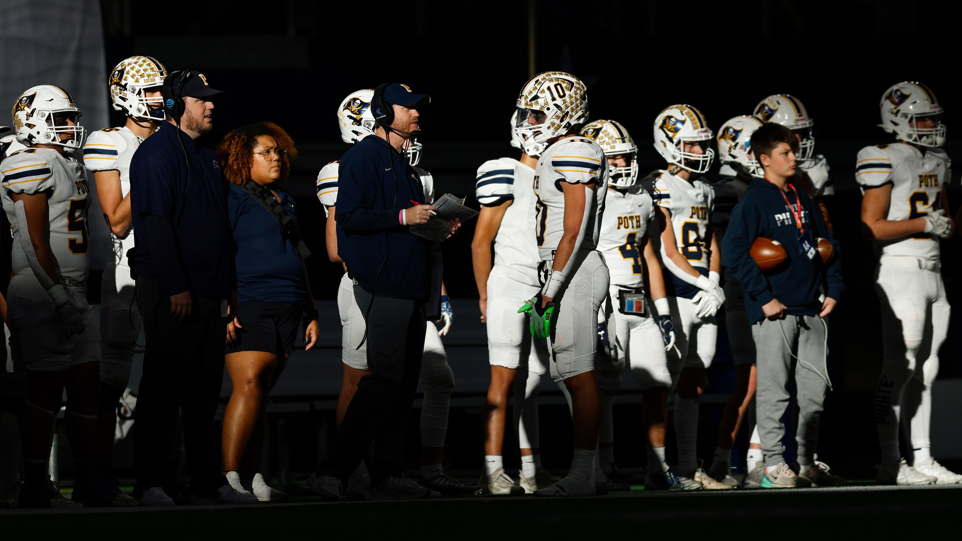 Members of the Poth  football team stand in the sun during the first half of the Class 3A...