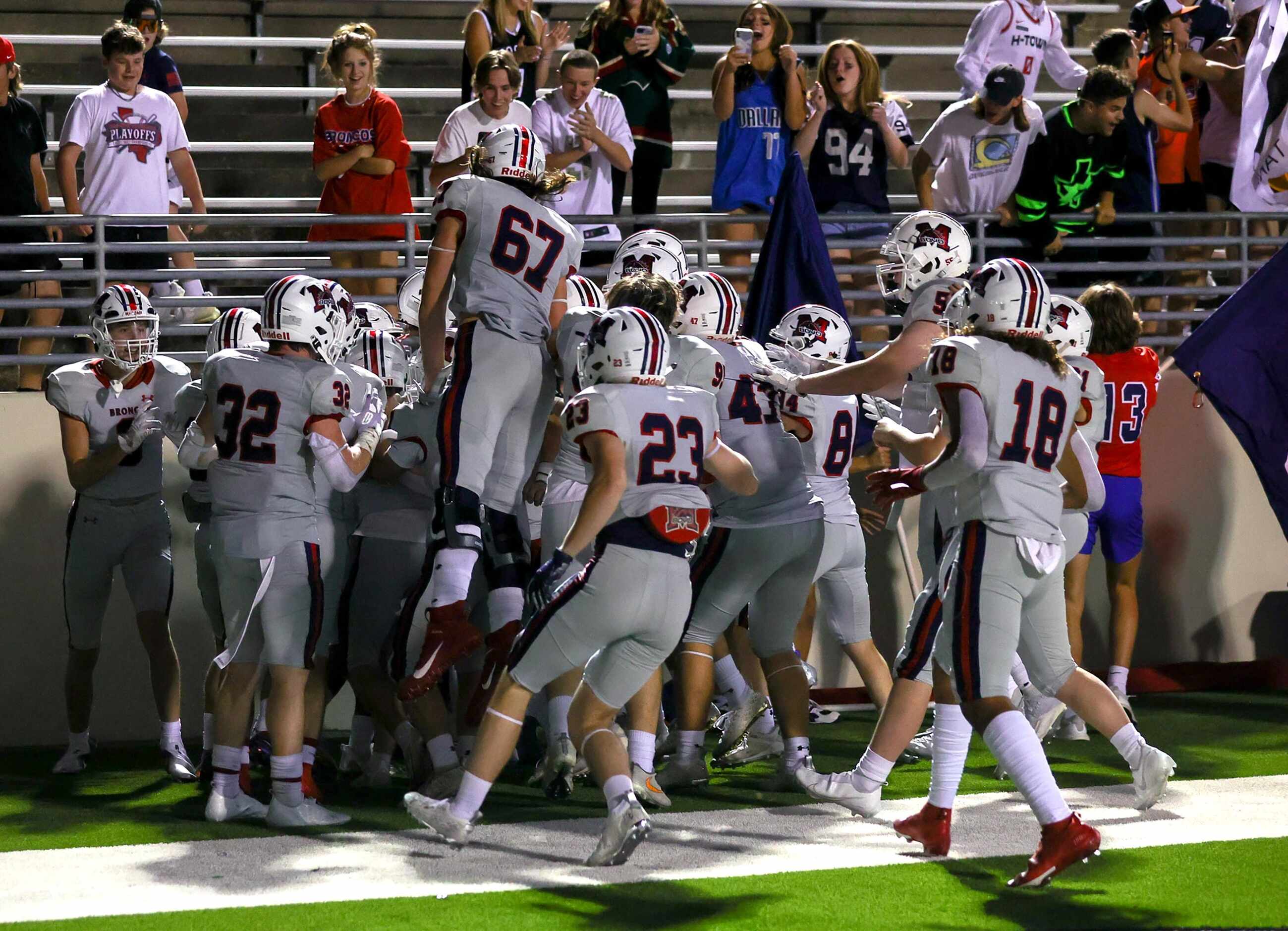 McKinney Boyd celebrate their victory over Denton Braswell, 37-34 in overtime in a District...