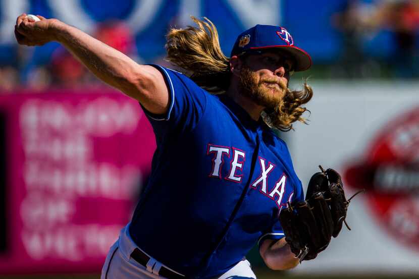 Texas Rangers starting pitcher A.J. Griffin (64) pitches during the third inning of a spring...