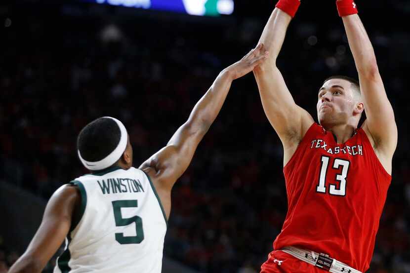 Texas Tech's #13 Matt Mooney shoots over Michigan State's #5 Cassius Winston during the...