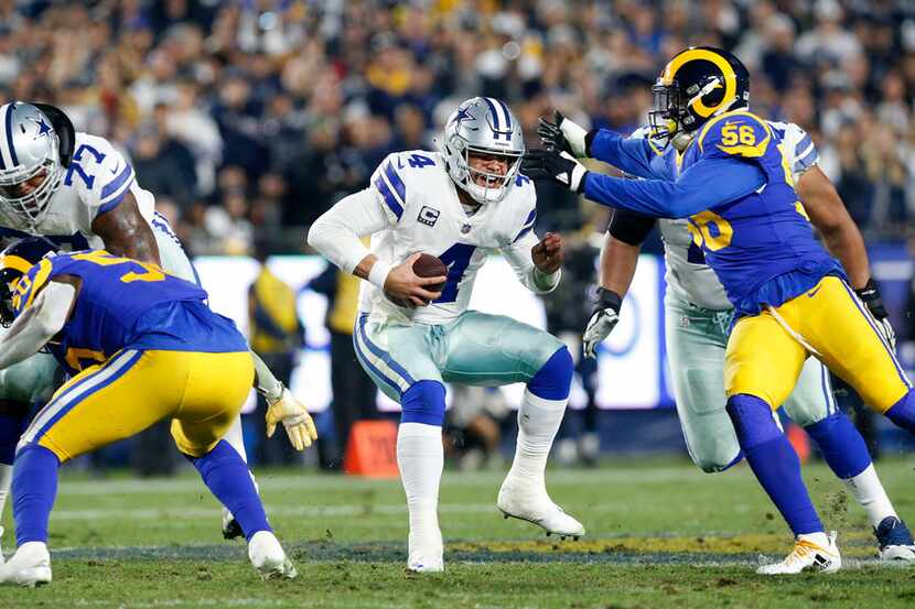 Dallas Cowboys quarterback Dak Prescott (4) takes off running before being sacked late in...