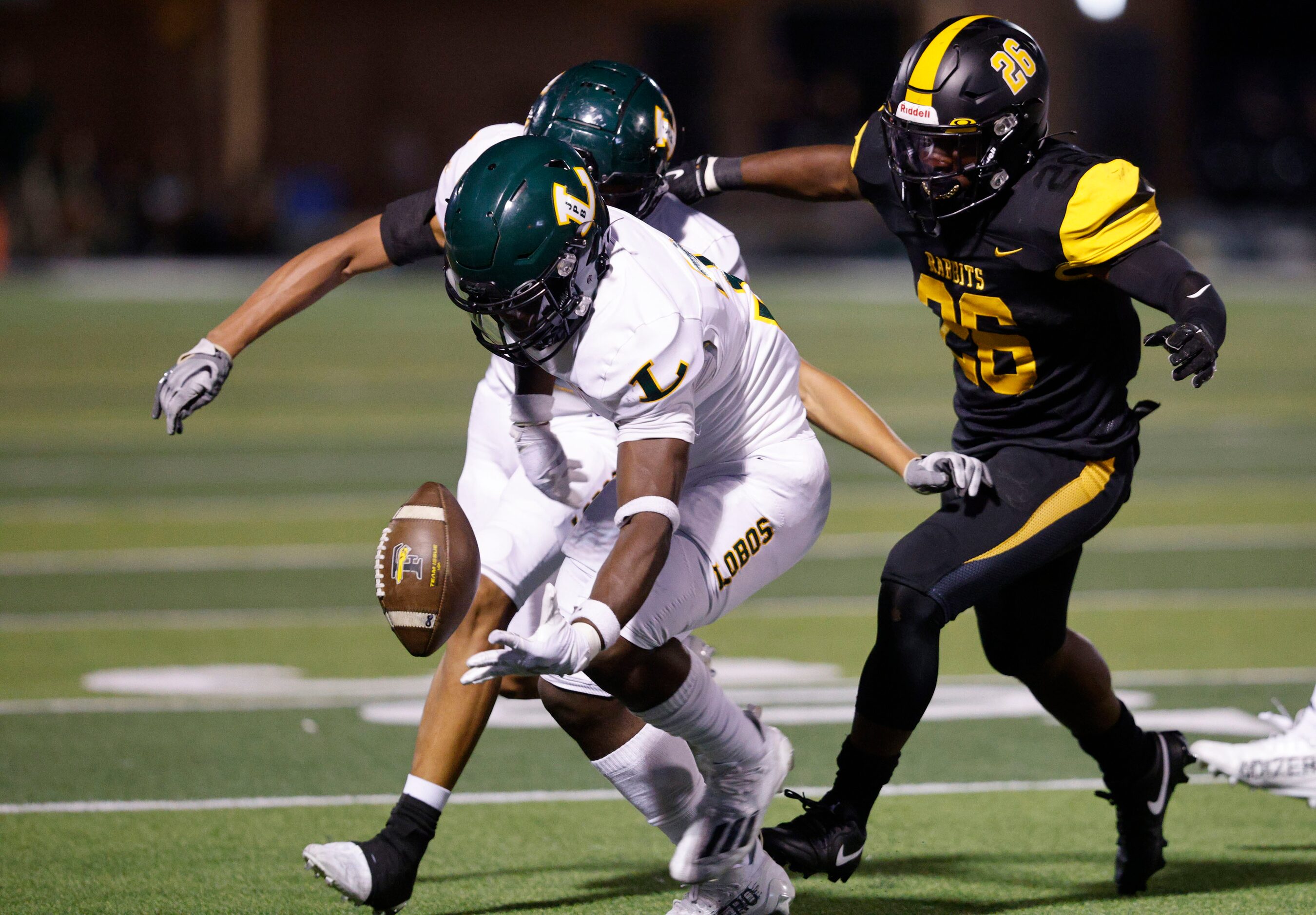 Longview's Kason Brooks (31) picks up the loose ball after Forney's Javian Osborne (26)...