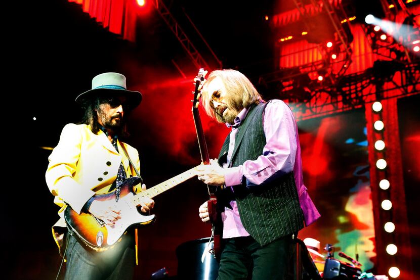 Guitarist Mike Campbell, left, performs with Tom Petty at the America Airlines Center...