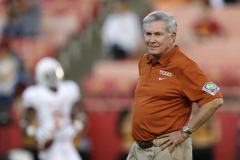 University of Texas football head coach Mack Brown watching his team warm up before a game...